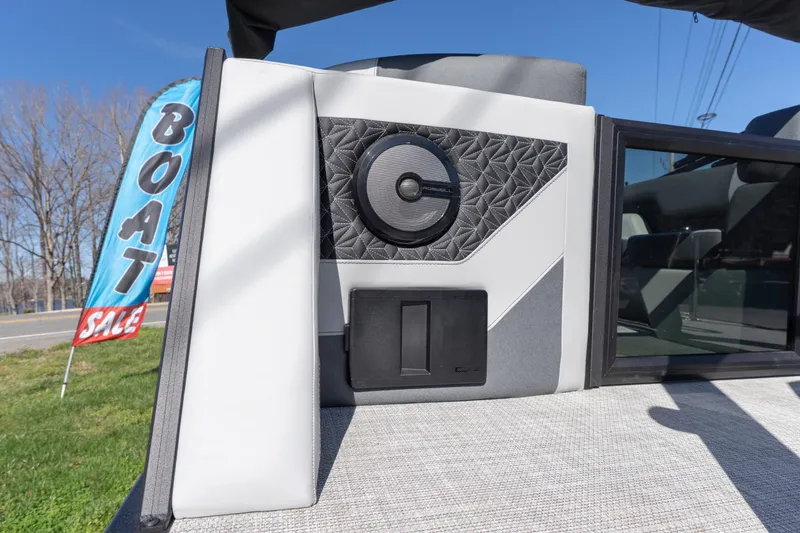 Slide: The Image of 2026 Alera M23Q boat interior with speaker detail, displayed at a boat sale event. - 18