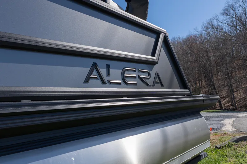 Slide: The Image of 2026 Alera M23Q vehicle rear view with logo, outdoors on a sunny day. - 2
