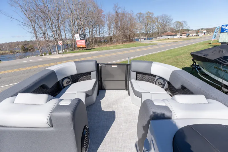 Slide: The Image of Interior view of 2026 Alera M23Q pontoon boat with gray seating and open gate. - 3