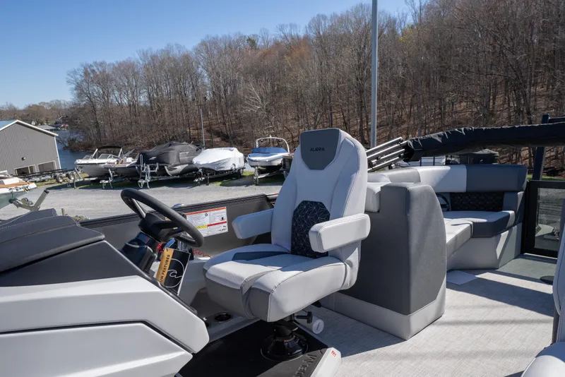 Slide: The Image of 2026 Alera M23Q boat interior with modern seating and steering wheel. - 7