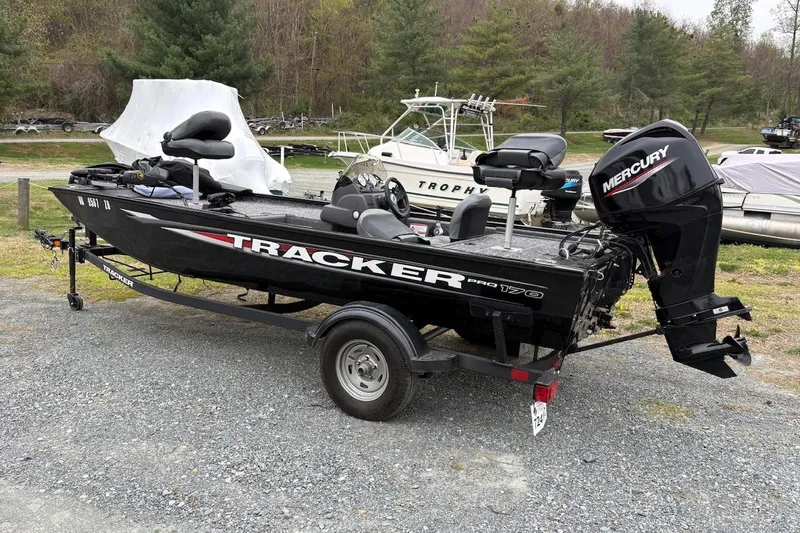 The Image of 2025 Tracker Pro 170 boat with Mercury engine on a trailer, parked outdoors. - 0