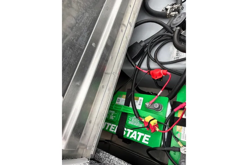 Slide: The Image of Battery compartment of 2025 Tracker Pro 170 boat with wiring connections. - 13