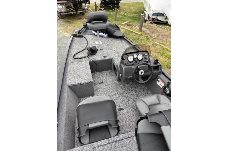 Slide: The Image of 2025 Tracker Pro 170 boat interior with steering console and seating. - 3