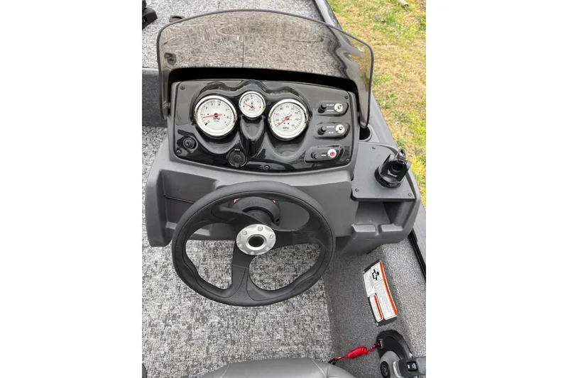 Slide: The Image of 2025 Tracker Pro 170 boat dashboard with steering wheel and gauges. - 6
