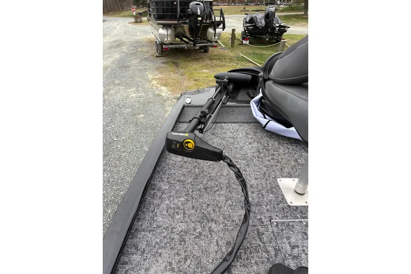 Slide: The Image of 2025 Tracker Pro 170 boat with trolling motor on a gravel path. - 8