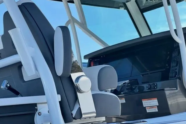 Slide: The Image of 2022 Blackfin 332 CC boat interior with modern helm and seating. - 18