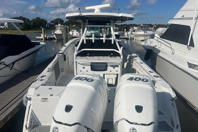 Slide: The Image of 2022 Blackfin 332 CC boat with twin 400 engines docked at a marina. - 5