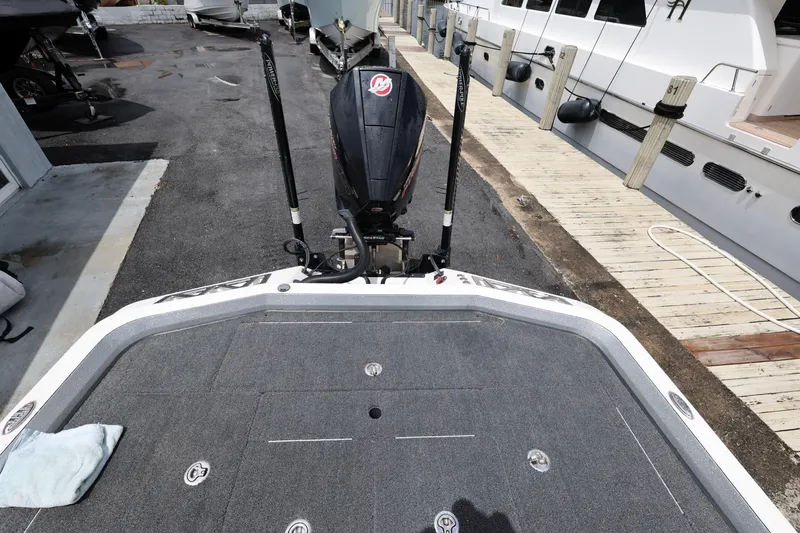Slide: The Image of 2020 Ranger Z520L boat with motor, docked beside a wooden pier. - 21