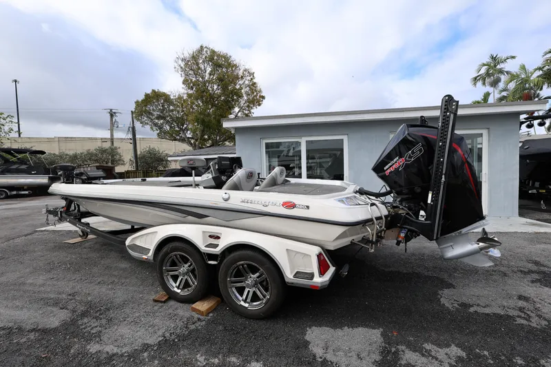 Slide: The Image of 2020 Ranger Z520L boat with powerful engine, parked outdoors near a building. - 3
