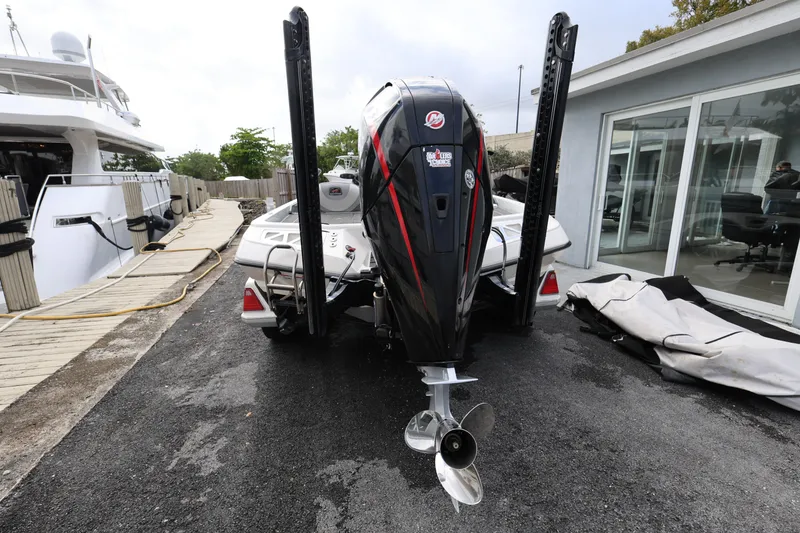 Slide: The Image of 2020 Ranger Z520L boat with powerful outboard motor, docked near a marina. - 4