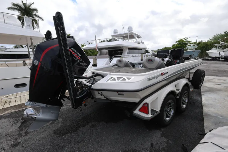 Slide: The Image of 2020 Ranger Z520L boat with powerful outboard motor in a marina setting. - 5