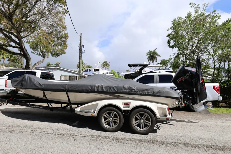 Slide: The Image of 2020 Ranger Z520L boat on trailer, covered, parked outdoors. - 8