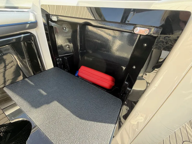 Slide: The Image of Yamaha Boats 242 Limited S 2018 storage compartment with red case. - 18