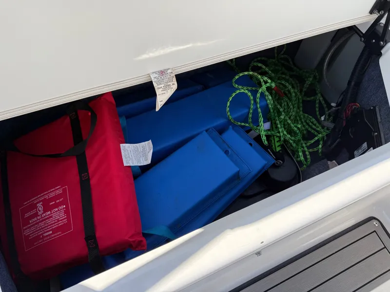 Slide: The Image of Storage compartment in Yamaha 242 Limited S boat with life jacket and rope. - 26