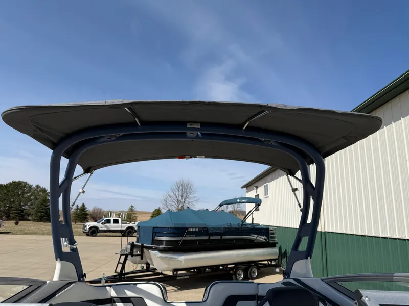 Slide: The Image of Yamaha Boats 242 Limited S 2018 with boat canopy, parked outdoors. - 32