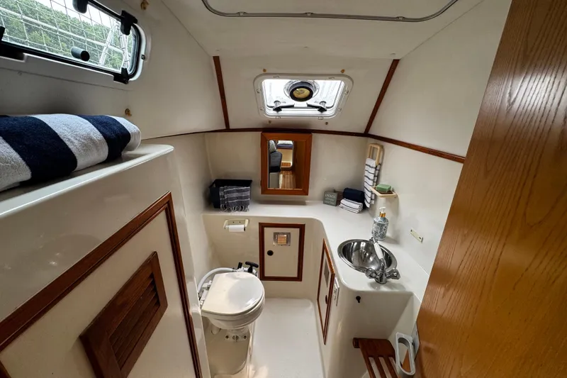 Slide: The Image of Compact bathroom in 1991 PDQ 36 boat with sink, toilet, and storage. - 14
