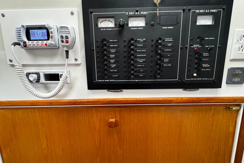 Slide: The Image of Control panel of a 1991 PDQ 36 boat with radio and electrical switches. - 15