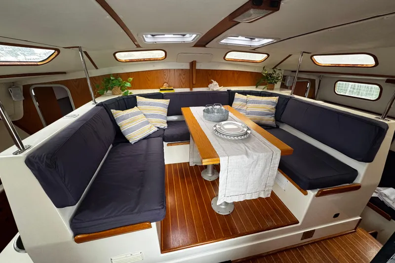 Slide: The Image of Cozy interior of 1991 PDQ 36 yacht with cushioned seating and dining table. - 18
