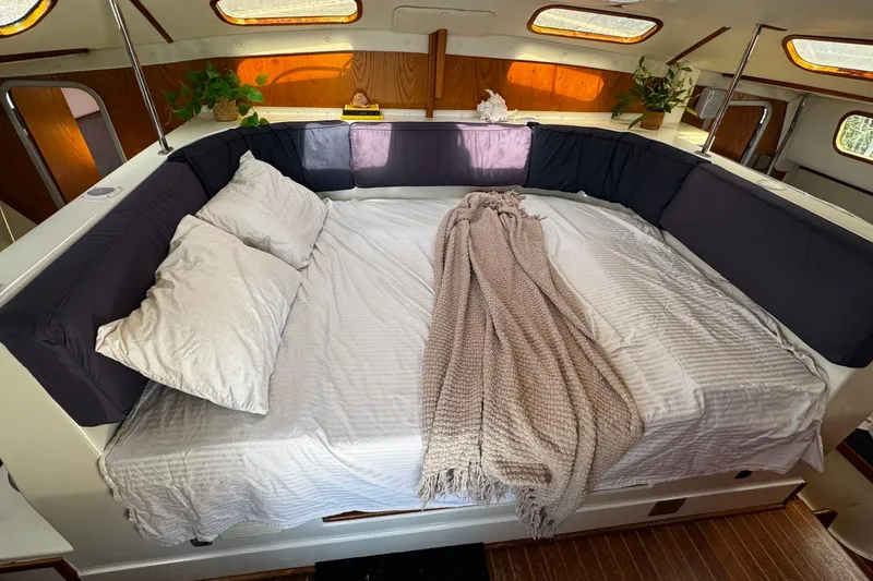 Slide: The Image of Cozy cabin interior of 1991 PDQ 36 with a neatly made bed and soft lighting. - 20