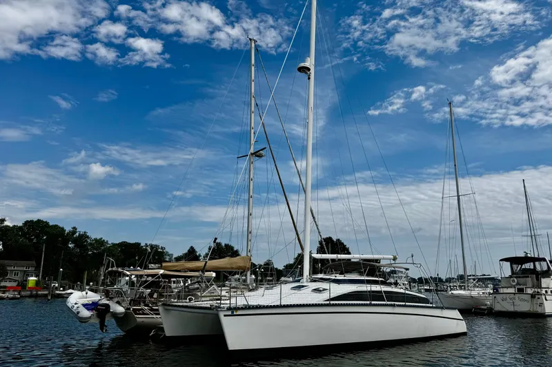Slide: The Image of Sailboat PDQ 36, 1991 model, docked in a marina under a blue sky. - 5
