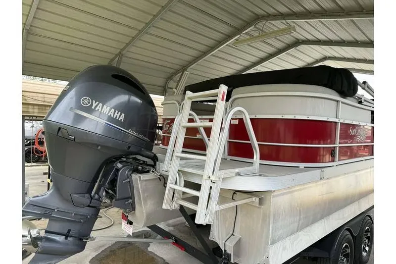 Slide: The Image of 2016 G3 Angler V145 boat with Yamaha motor under a metal shelter. - 1