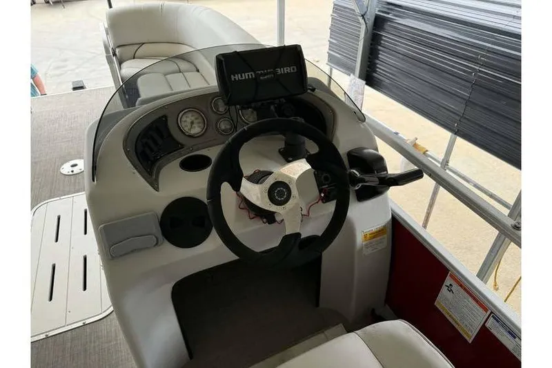 Slide: The Image of 2016 G3 Angler V145 boat dashboard with steering wheel and Humminbird fish finder. - 10