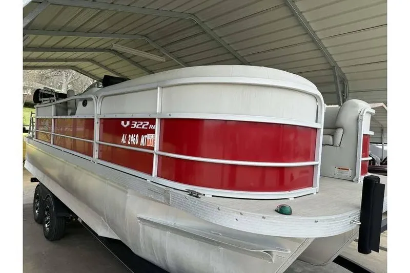 Slide: The Image of 2016 G3 Angler V145 boat with red and white exterior under a metal canopy. - 3