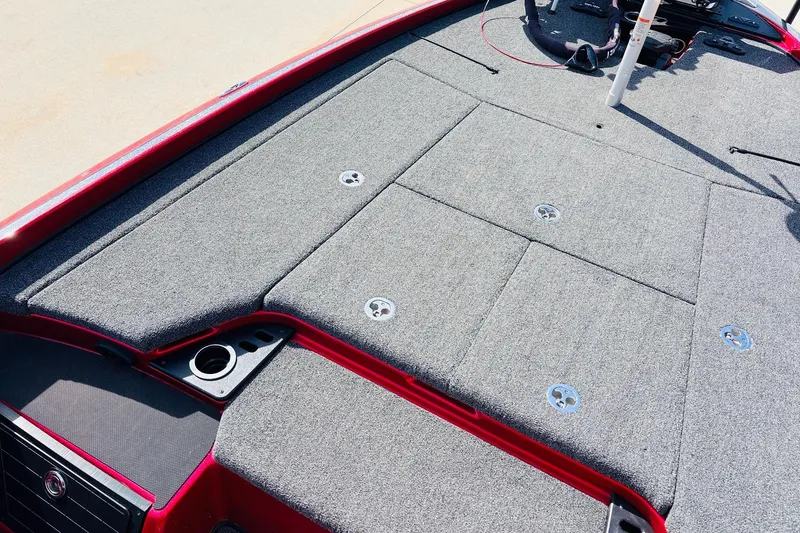 Slide: The Image of 2020 Nitro Z21 Pro boat deck with gray carpet and red trim. - 20