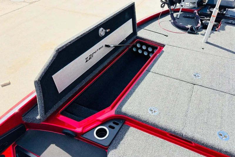 Slide: The Image of 2020 Nitro Z21 Pro boat storage compartment with open lid, showcasing interior design and features. - 22