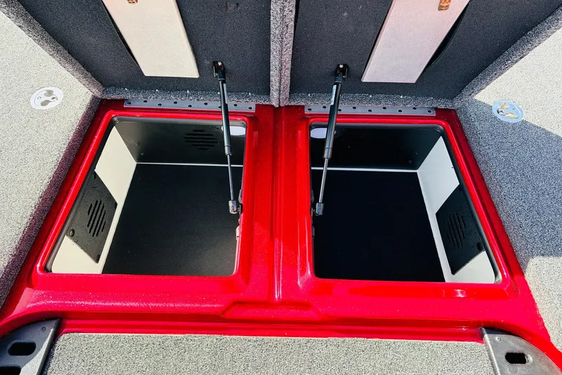 Slide: The Image of Open storage compartments on a 2020 Nitro Z21 Pro boat, featuring red trim and hydraulic lifts. - 32