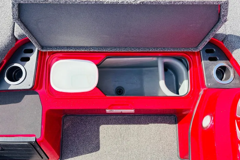 Slide: The Image of 2020 Nitro Z21 Pro boat storage compartment with cup holders and red interior. - 34