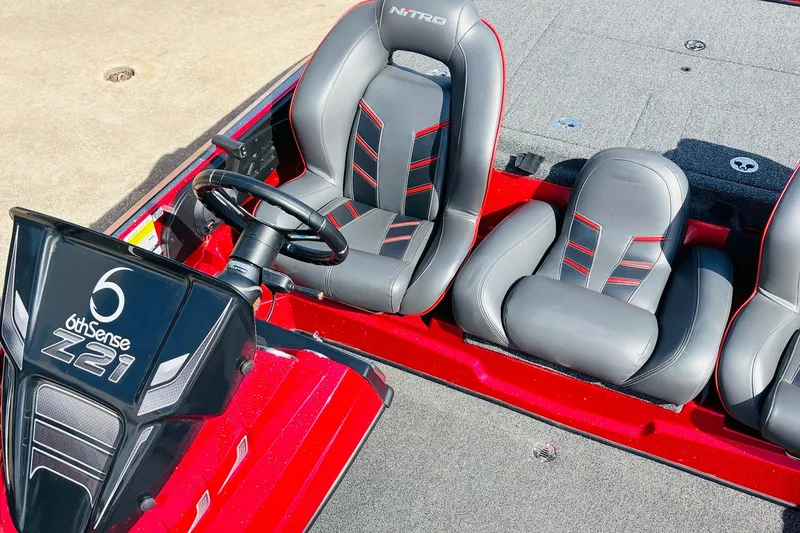 Slide: The Image of 2020 Nitro Z21 Pro boat interior with sleek black and red seating. - 40