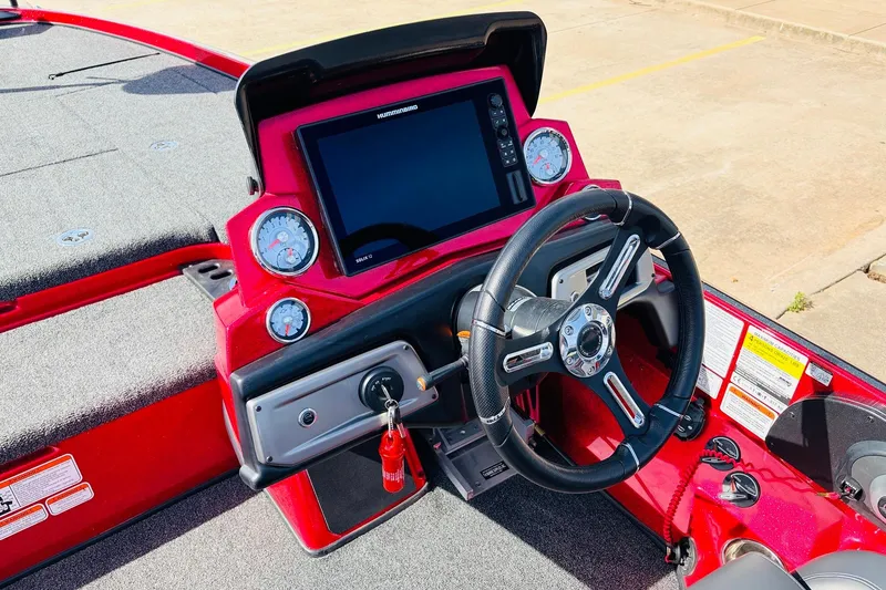 Slide: The Image of 2020 Nitro Z21 Pro boat dashboard with steering wheel and electronic display. - 42