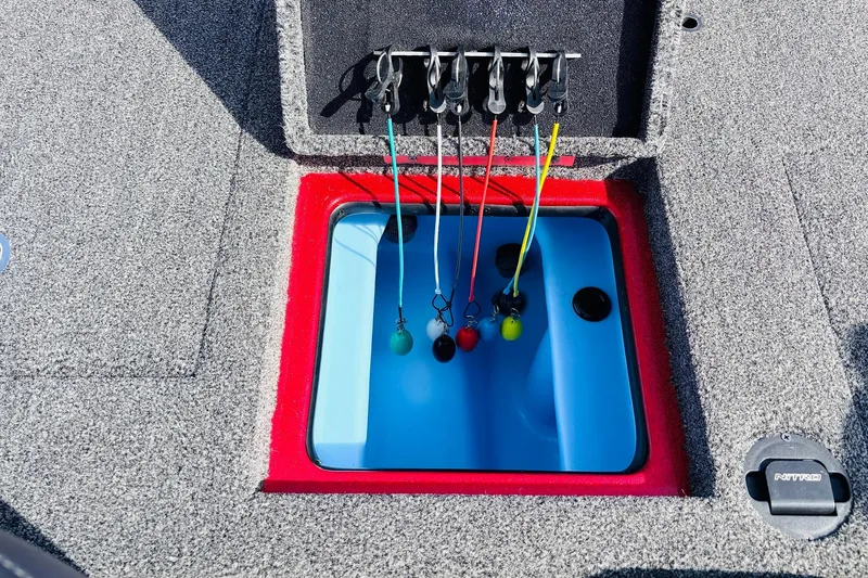 Slide: The Image of Livewell compartment in 2020 Nitro Z21 Pro boat with fishing line holders. - 48