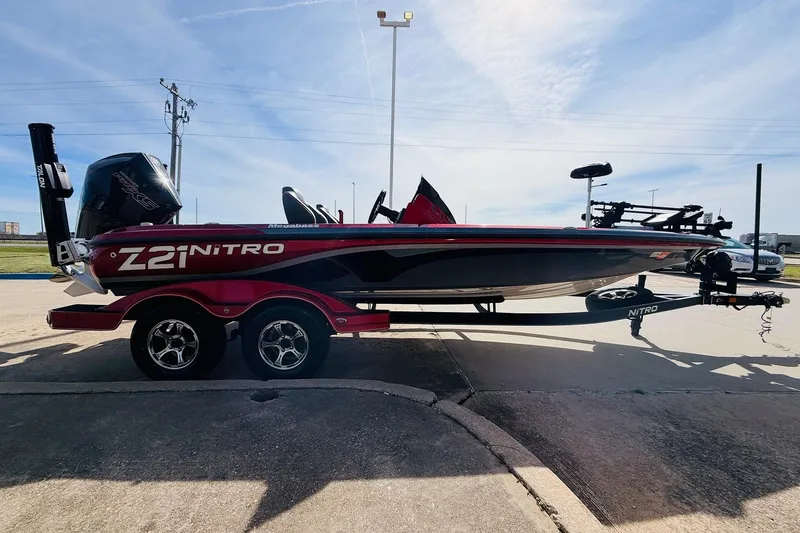 Slide: The Image of 2020 Nitro Z21 Pro boat on trailer, parked outdoors under a clear sky. - 5