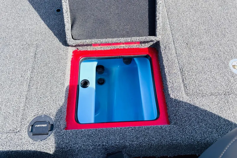Slide: The Image of Open storage compartment on a 2020 Nitro Z21 Pro boat, featuring a blue interior. - 50