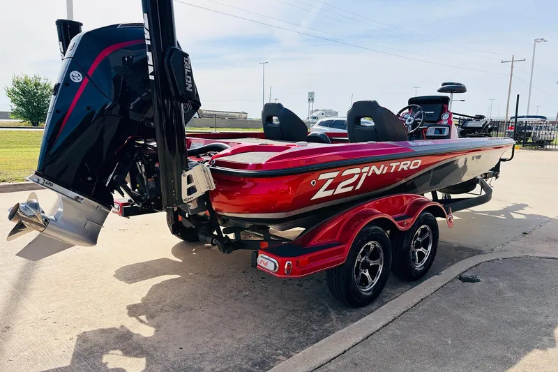 Slide: The Image of 2020 Nitro Z21 Pro boat with powerful engine, sleek red design, and dual-axle trailer. - 6