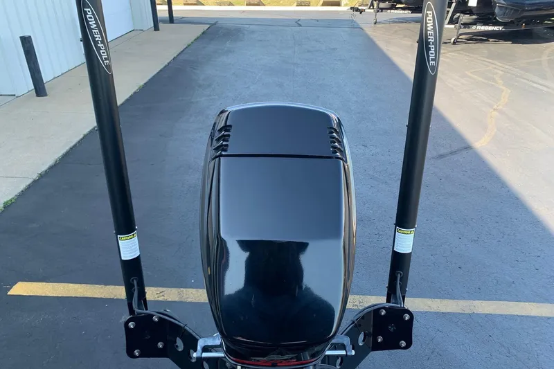 Slide: The Image of 2001 Ranger R83 boat with Power-Pole anchors on a paved surface. - 10