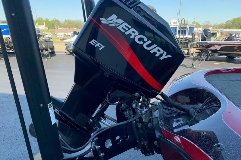 Slide: The Image of 2001 Ranger R83 boat with Mercury EFI outboard motor in a parking lot. - 9