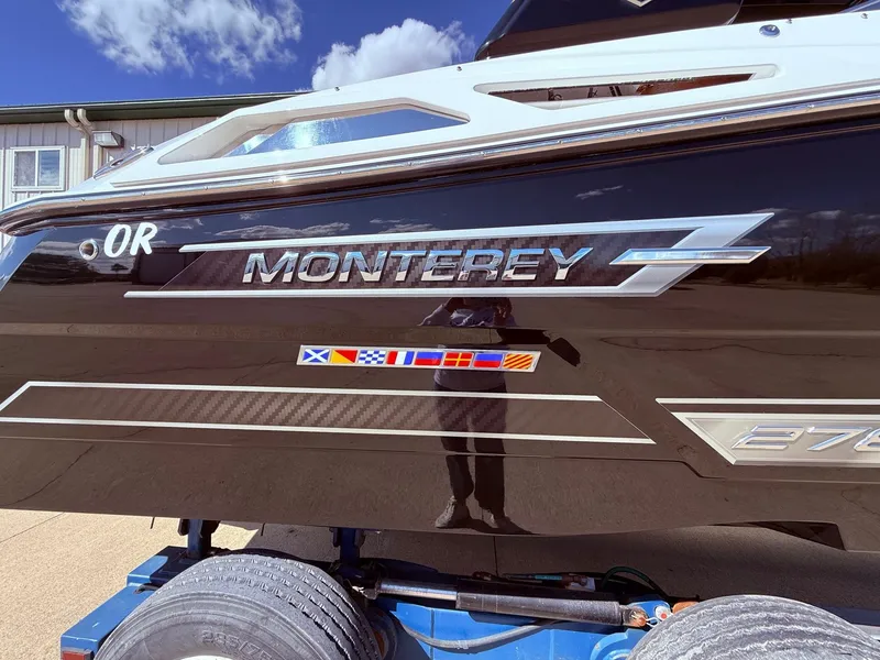 Slide: The Image of 2022 Monterey 278SS Super Sport boat with glossy black hull. - 48