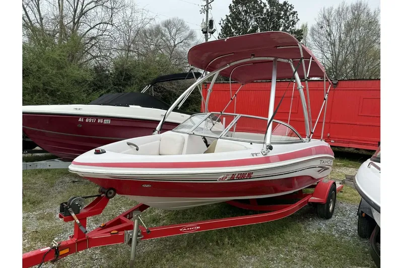 Slide: The Image of 2005 Tahoe Q4 Sport boat with red and white design on a trailer. - 7