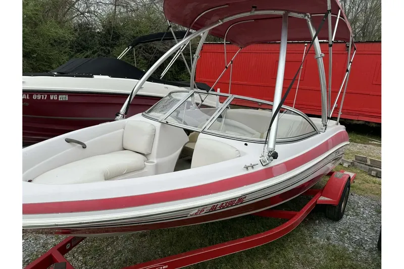 Slide: The Image of 2005 Tahoe Q4 Sport boat with red and white design on a trailer. - 8