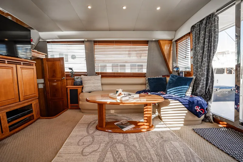 Slide: The Image of Luxurious interior of 2004 Navigator 5700 Rival Pilothouse yacht with cozy seating and elegant decor. - 16