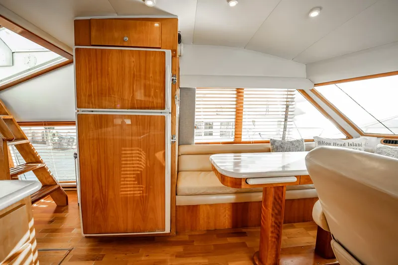 Slide: The Image of Luxurious interior of 2004 Navigator 5700 Rival Pilothouse with wood finishes and seating area. - 24