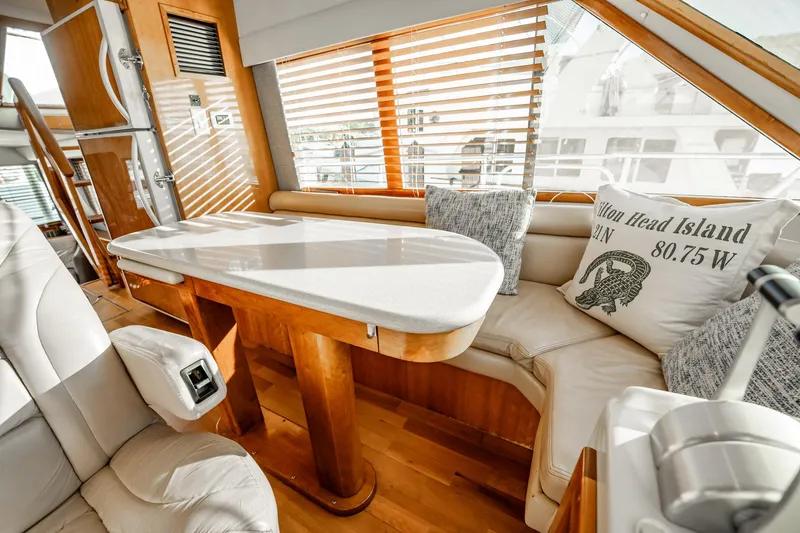 Slide: The Image of Luxurious interior of 2004 Navigator 5700 Rival Pilothouse with plush seating and elegant table. - 25