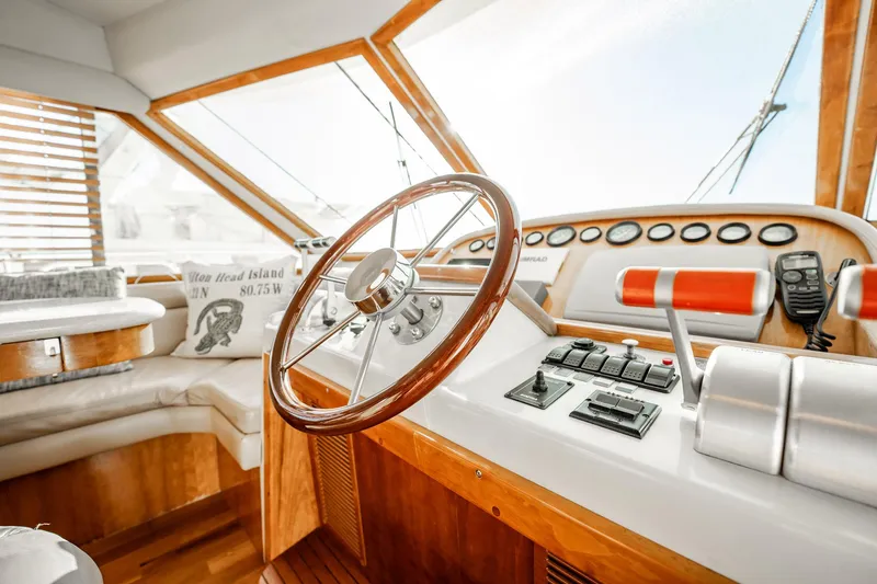 Slide: The Image of Pilothouse interior of 2004 Navigator 5700 Rival, featuring steering wheel and control panel. - 27