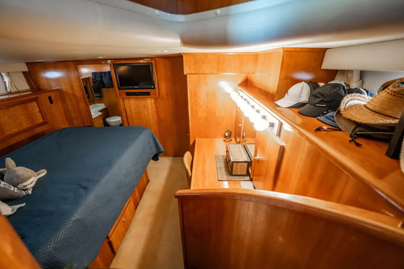 Slide: The Image of Luxurious 2004 Navigator 5700 Rival Pilothouse cabin with wood interior and cozy bed. - 29