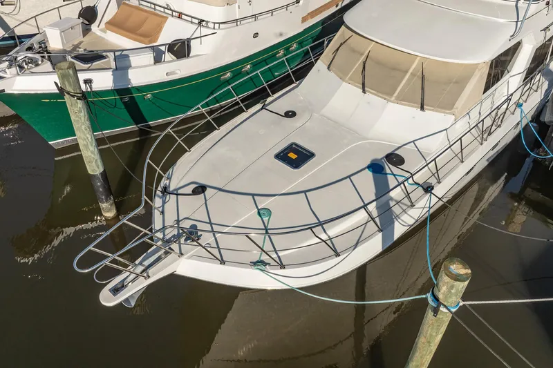 Slide: The Image of 2004 Navigator 5700 Rival Pilothouse yacht docked at marina, top view. - 3