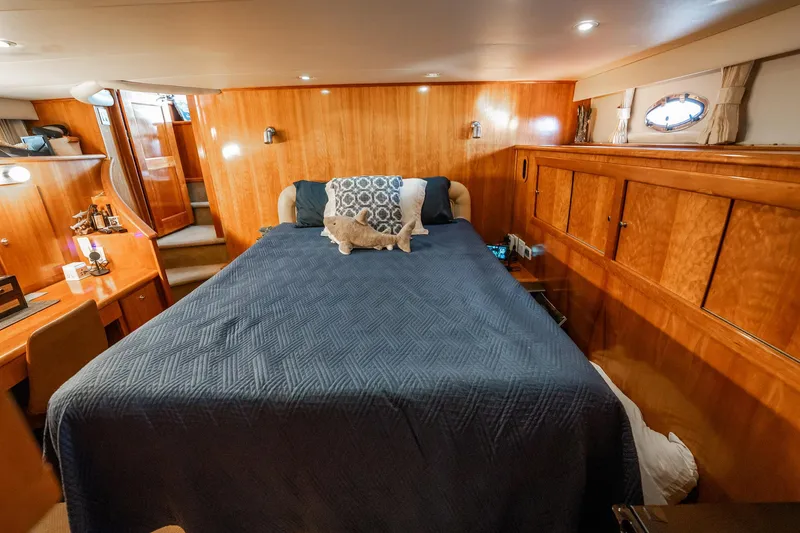 Slide: The Image of Luxurious 2004 Navigator 5700 Rival Pilothouse bedroom with wood paneling and cozy bedding. - 30