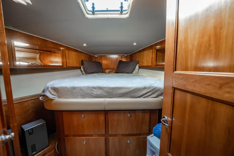 Slide: The Image of Cozy cabin interior of 2004 Navigator 5700 Rival Pilothouse with wooden finish and bed. - 36